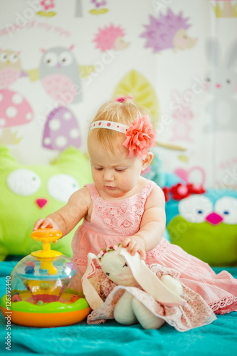 The baby playing with toys  in room