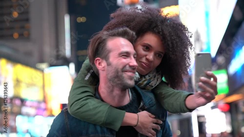Couple at Times Square taking selfie picture