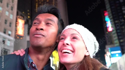 Couple at Times Square laughing outloud