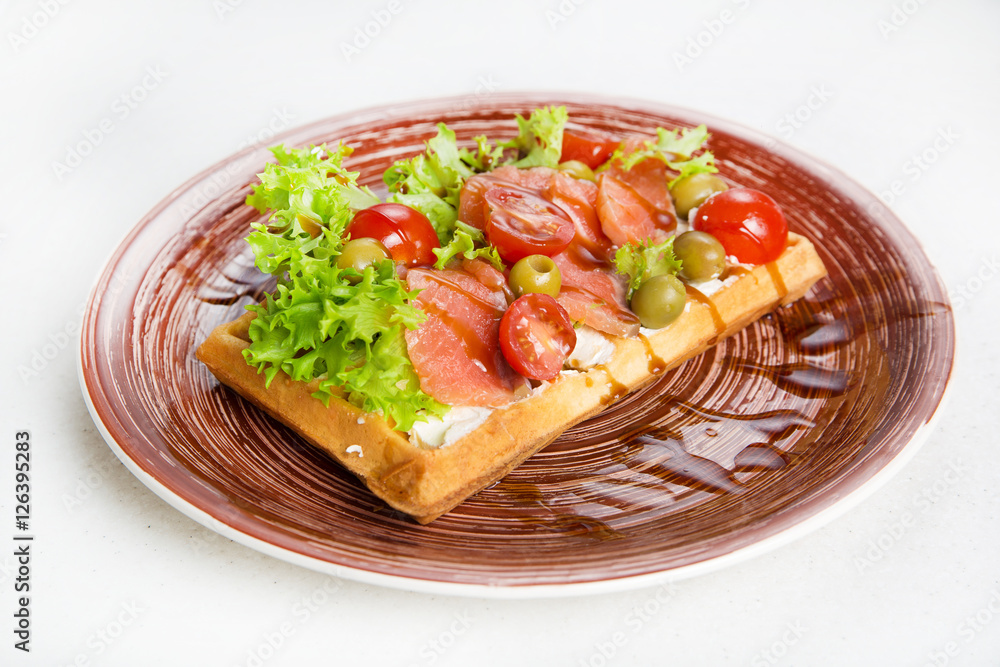 Plate of belgian waffles with salmon, tomatoes, herbs and balsamic vinegar Plate of belgian waffles with salmon, tomatoes, herbs and balsamic vinegar