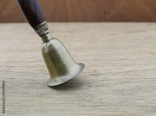 Ancient bronze bell on wood background