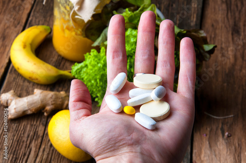 Wallpaper Mural Choice between vitamins from supplements or from vegetables and fruits Torontodigital.ca