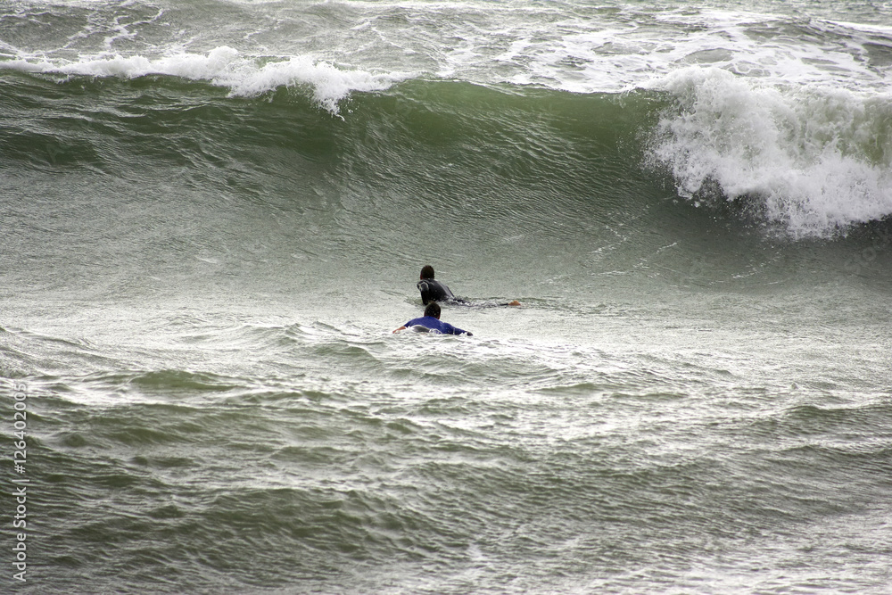 a surfer surf a wave in italy