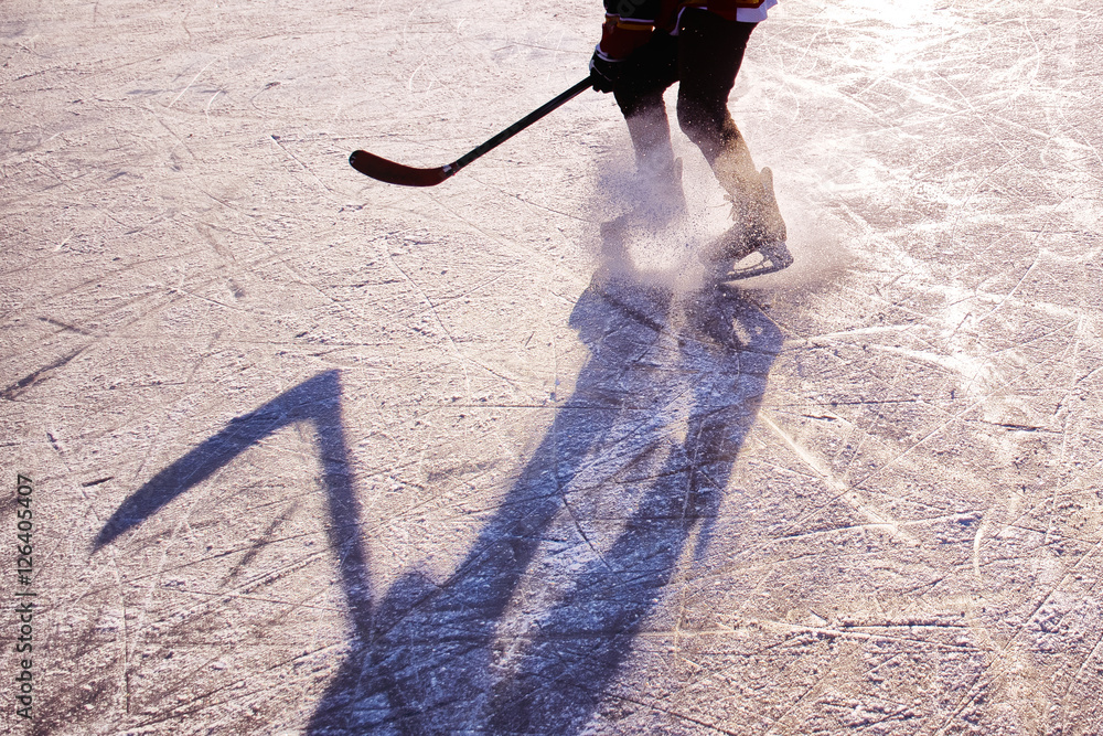 Obraz premium hockey player on the ice on sunset - black and white photo