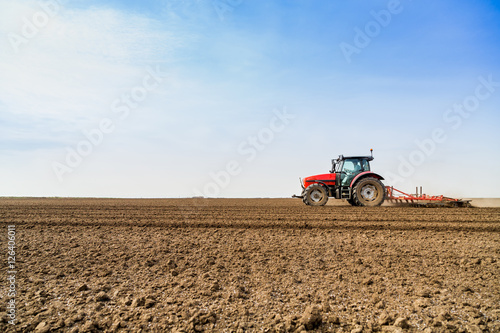 Farmer in tractor preparing land with seedbed cultivator © oticki