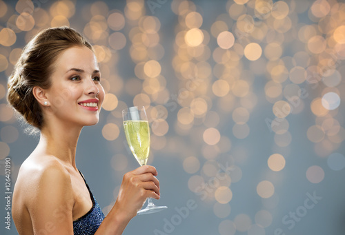 smiling woman holding glass of champagne