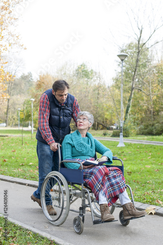 Son with Mother in wheel chair at the park 