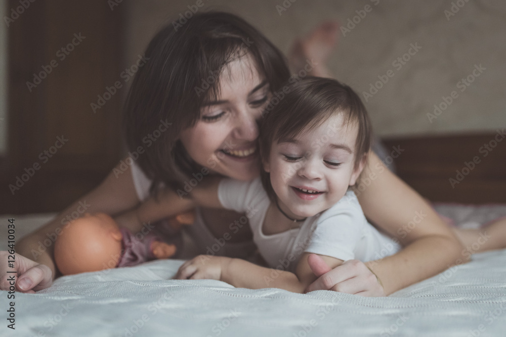 young dark haired mother and daughter Toddler playing, cuddling young dark haired mother and daughter Toddler playing, cuddling