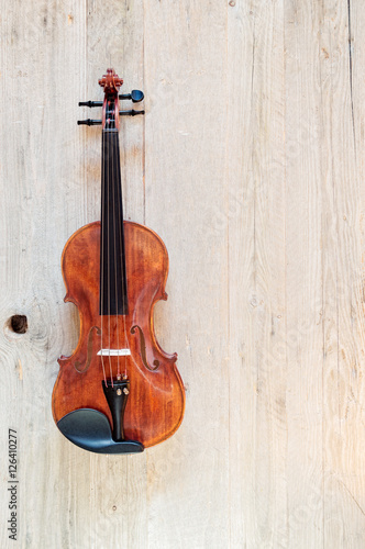 Wooden Classic Violin on a Weathered Wooden Background © Ana-Maria Tegzes