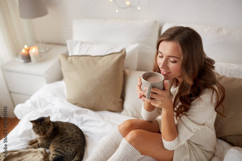 happy woman with cup of coffee in bed at home happy woman with cup of coffee in bed at home