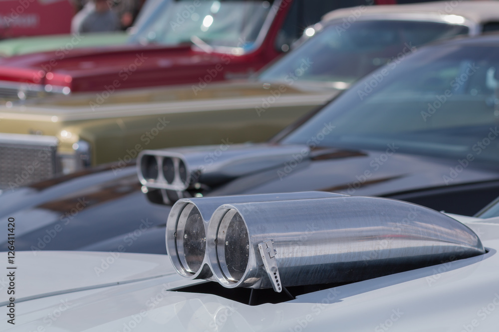 Close-up of an old car. Part of the exterior. An American classic. Chrome lining. Glass with reflection.