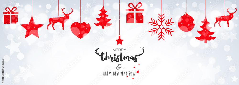 Christmas card with hanging red decorations on bokeh