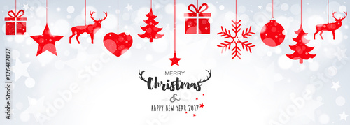 Christmas card with hanging red decorations on bokeh