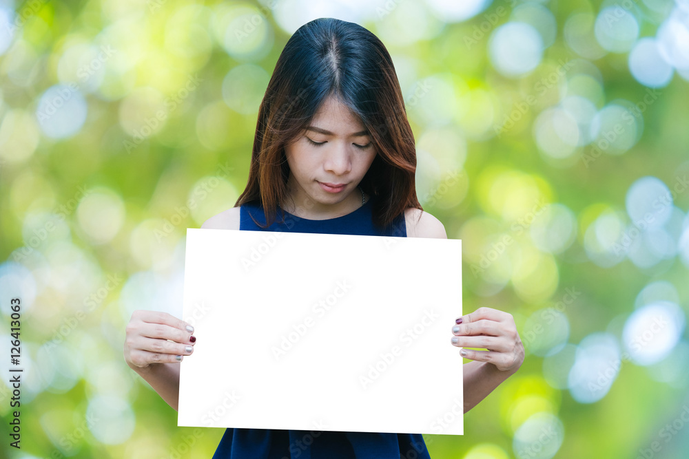 Portrait of a Beautiful asia woman holding a blank signboard with bokeh nature background. Portrait of a Beautiful asia woman holding a blank signboard with bokeh nature background.