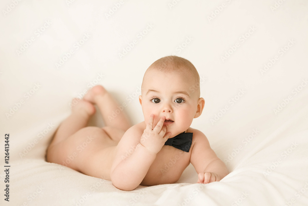 Incredible and charming newborn baby lying on a white background Incredible and charming newborn baby lying on a white background