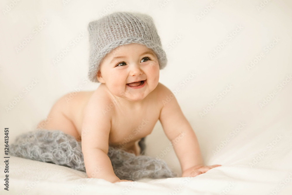 Incredible and happy newborn baby lying on a white background Incredible and happy newborn baby lying on a white background