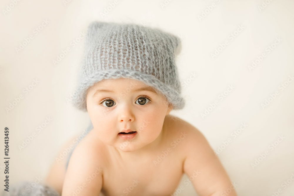 Incredible and charming newborn baby lying on a white background Incredible and charming newborn baby lying on a white background