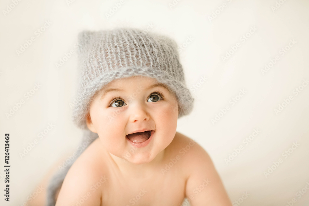 Incredible and happy newborn baby lying on a white background Incredible and happy newborn baby lying on a white background