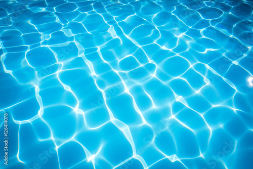 Beautiful ripple water in swimming pool with sun reflection