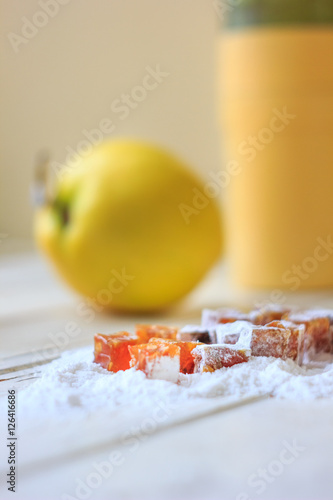 Quince jelly on sugar powder over the table