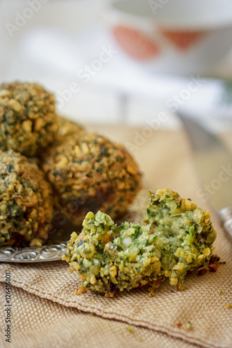 Chickpea falafel balls on metal plate. Falafel is vegetarian dish.