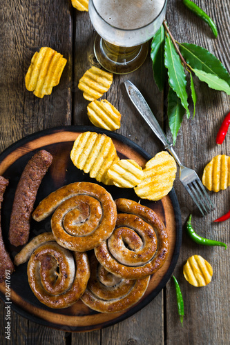 Grilled sausages, potato chips and beer