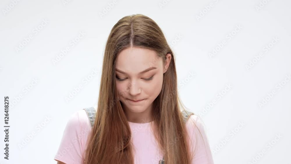 Shy young beautiful girl smiling over white background. Shy young beautiful girl smiling over white background.