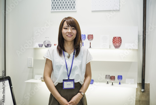 Saleswoman in a shop selling Edo Kiriko cut glass in Tokyo, Japan. photo