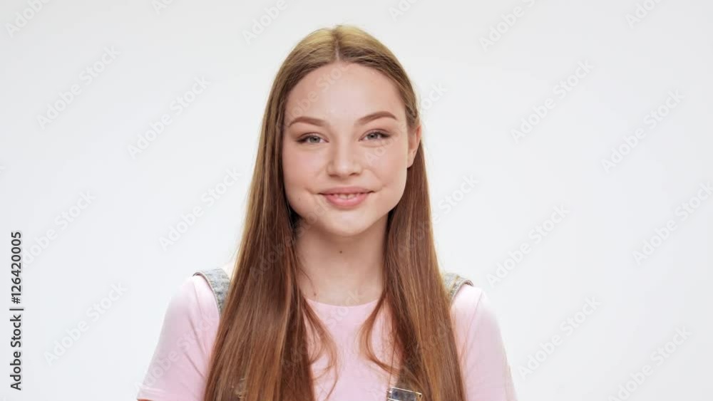 Young beautiful girl smiling over white background. Young beautiful girl smiling over white background.