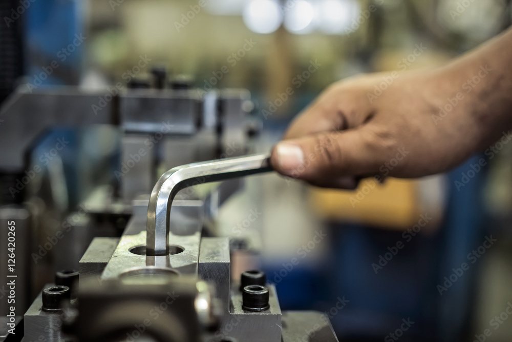 Worker is used Hexagonal screwdriver in factory Worker is used Hexagonal screwdriver in factory