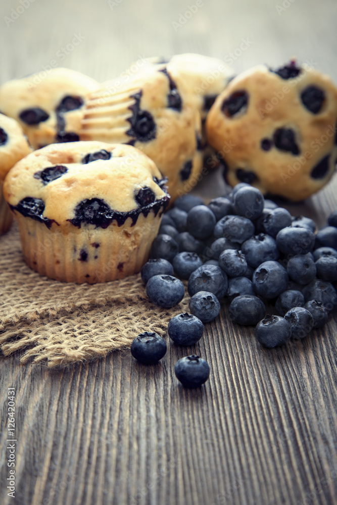 muffin with blueberries on a wooden table. fresh berries and swe muffin with blueberries on a wooden table. fresh berries and swe