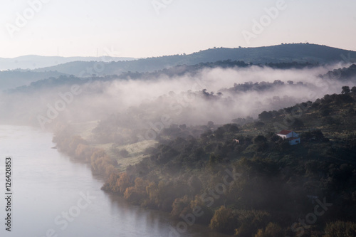 Foggy hills and river photo