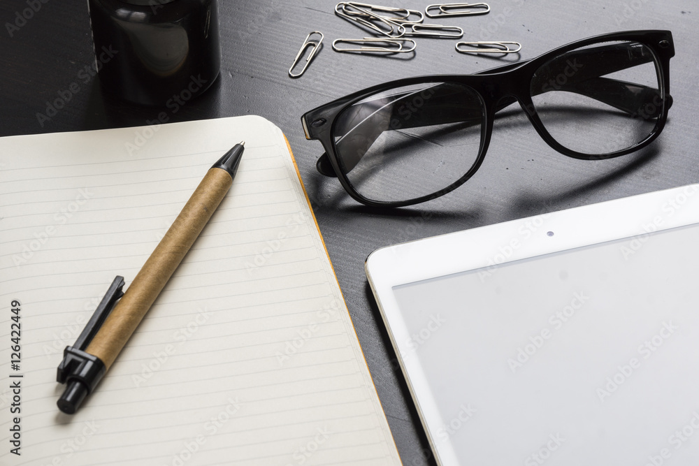 flat lay of workplace with white paper and yellow notebook, tablet flat lay of workplace with white paper and yellow notebook, tablet