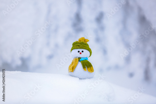 On the white fluffy textured  snowman. © Vitalii_Mamchuk