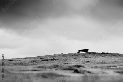 Lone bench on the hill landscape backdrop © spacedrone808