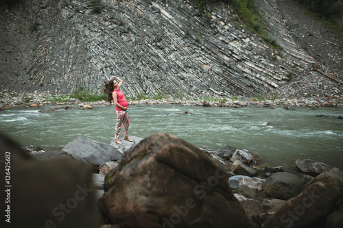 Beautiful pregnant woman posing near the river