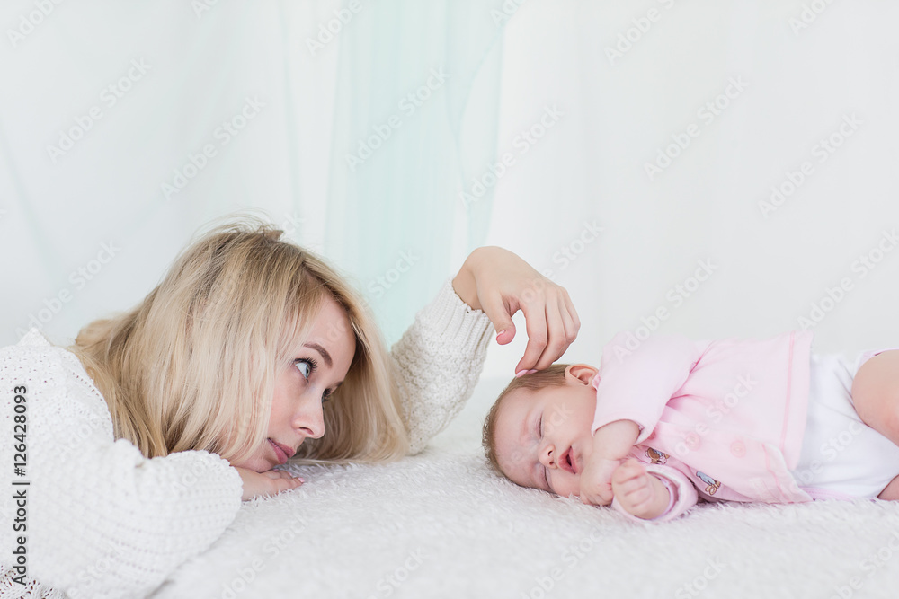 mother puts her baby daughter to sleep mother puts her baby daughter to sleep