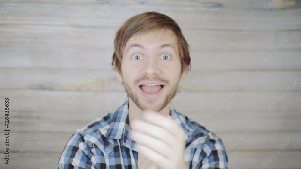 Portrait of a cheerful young man clapping hands Portrait of a cheerful young man clapping hands