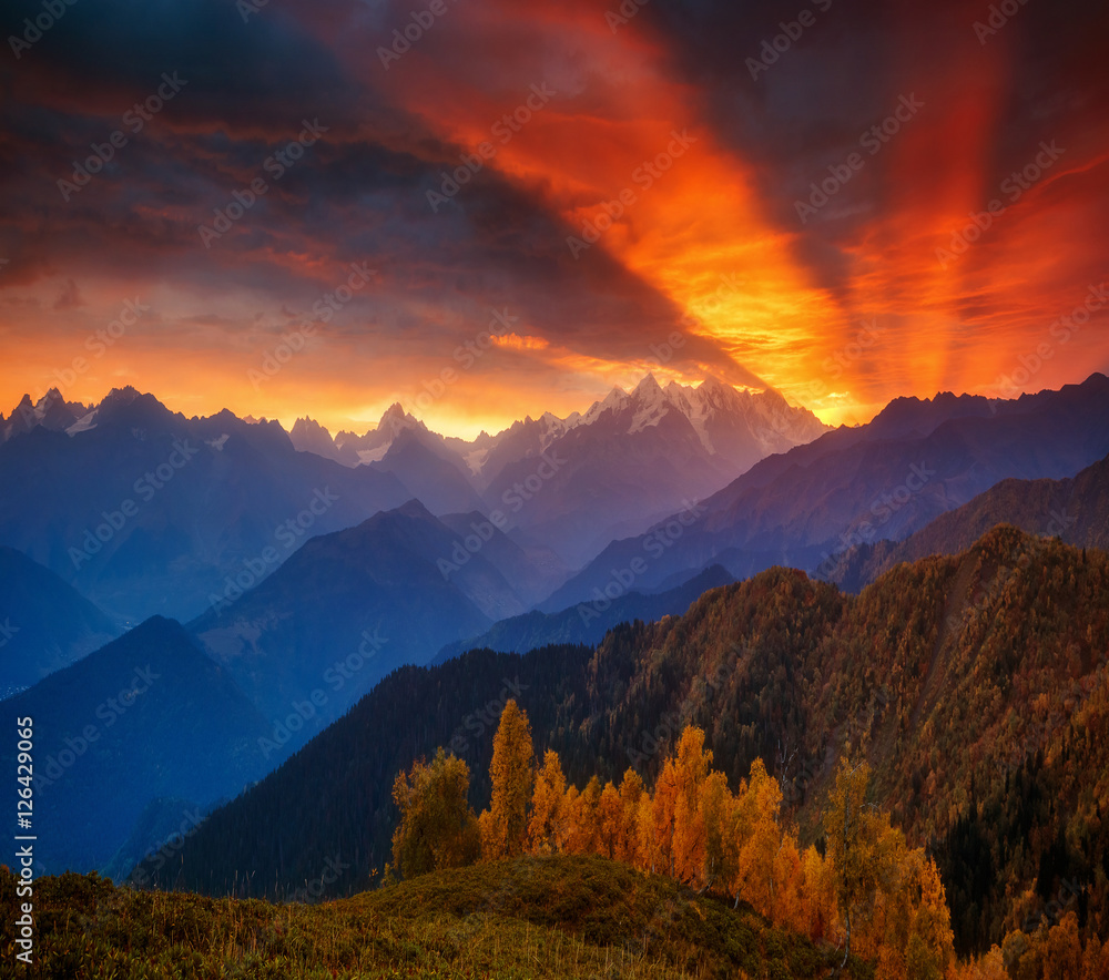 Fototapeta premium Fantastic red sunbeams. Location Upper Svaneti, Mestia, Georgia,