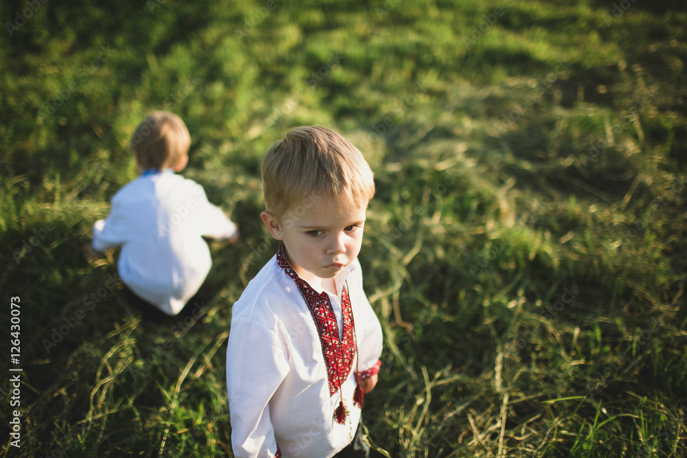 Cute little boys in traditional cloth outside Cute little boys in traditional cloth outside