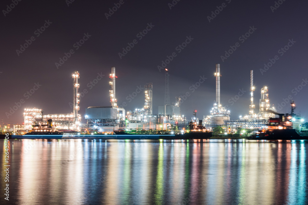 Oil refinery at night , reflection with river
