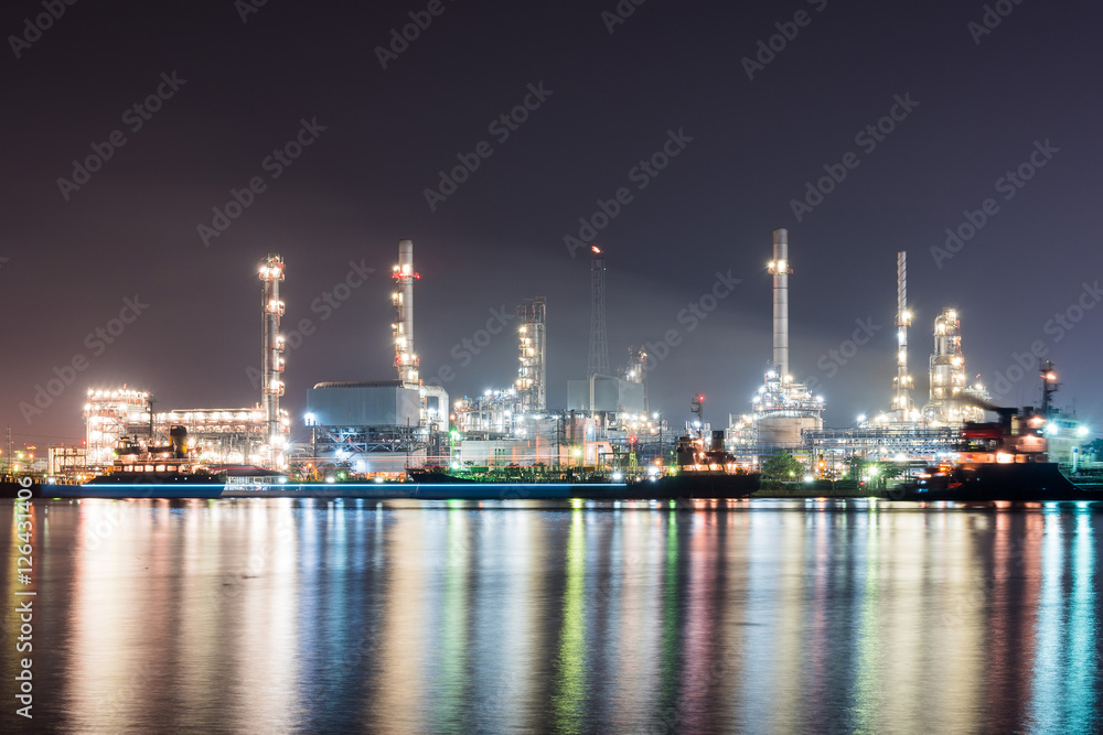 Oil refinery at night , reflection with river Oil refinery at night , reflection with river