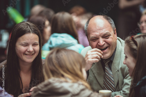 Father with daughter sitting in the cafe outside