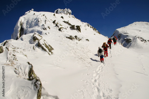 People hiking in beautiful winter mountains