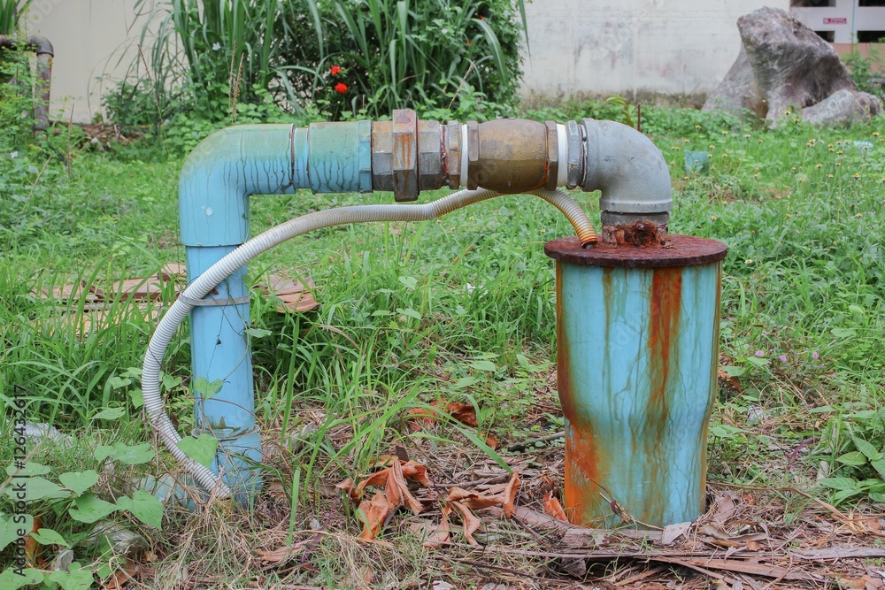 Water valve Plumbing Steel dilapidated on grass. old rusty Water valve Plumbing Steel dilapidated on grass. old rusty