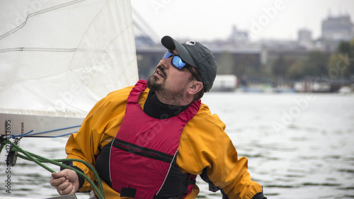 Man in the Finn Class sailboat participates in one of the match race regattas on the Sava river, Belgrade, Serbia