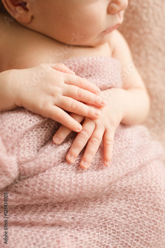 tiny hands of incredible and sweet newborn baby