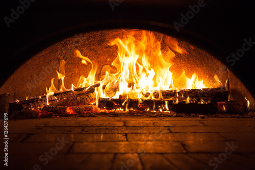 Tela Image of a brick pizza oven with fire
