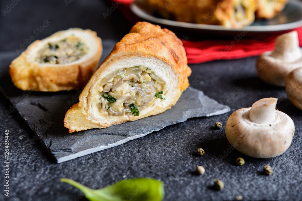 Fried rolls coated in batter and stuffed with mushroom, cheese, onion and parsley   