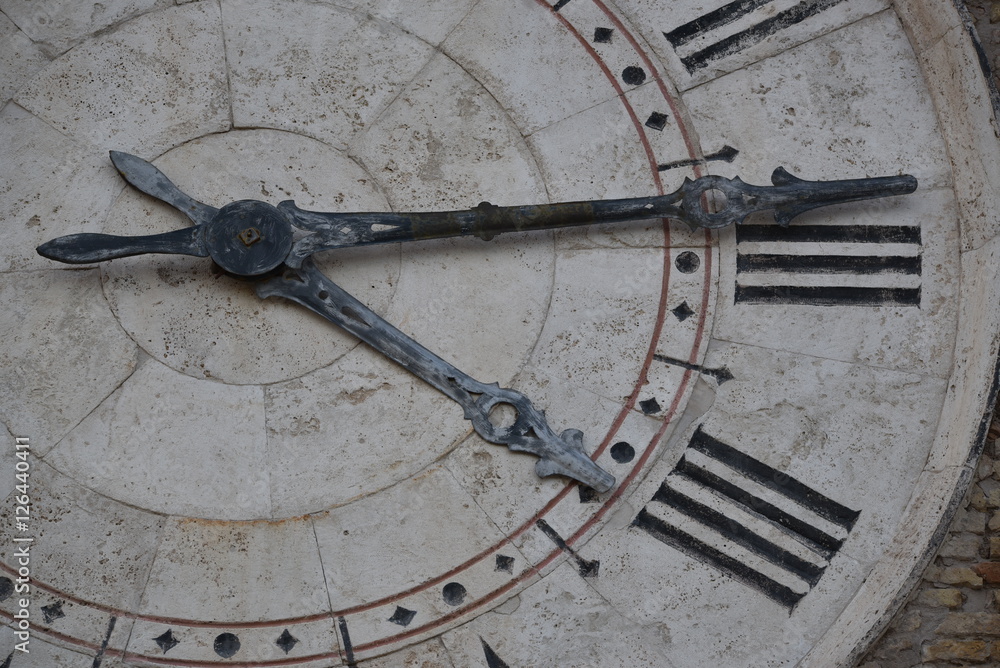 Clock tower partial view over hands and roman numbers, San Benedetto del Tronto, Italy
